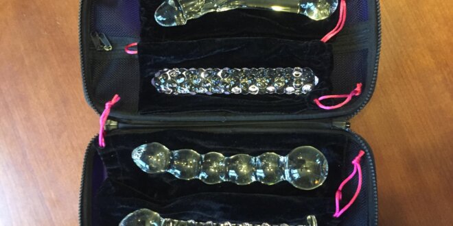 Lovehoney Glass dildos; realistic, nubby-textured, bulbed, and spirals g-spot. Dildos are in an open black storage case