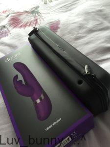 Black outer packaging and black zipped storage case for the Lovehoney Desire Rechargeable rabbit . The case has a hole for discreet charging.