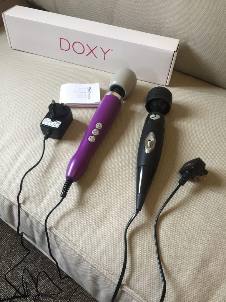 The Purple Doxy Mains Powered Wand Massager next to the Lovehoney Black Mains Powered wand