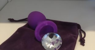 Purple silicone butt plug with faux crystal gem removed from the base. From the So Divine range of adult toys.