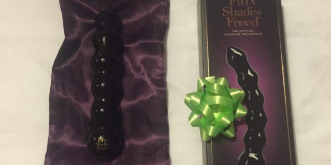 Purple satin storage pouch, black beaded glass dildo and outer packaging for the Fifty Shades Freed It's Divine Beaded Glass Wand