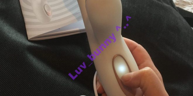 Rechargeable white Silicone rabbit vibrator with clitoral suction, from Satisfyer. view of front, with illuminated power button.