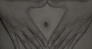 Woman's navel framed by her hands