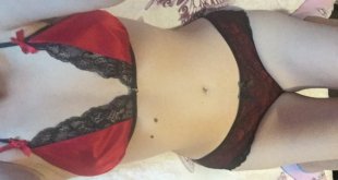 Luv Bunny wearing a red bra with black lace trim and black mesh pants