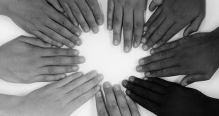 hands from various ethnicities arranged in a circle and using a filter to show it doesn't matter if you're black or white