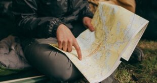 woman in a tent pointing at a map